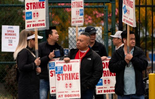 Boeing factory workers and supporters gather on a picket line near the entrance to a Boeing production facility in Renton