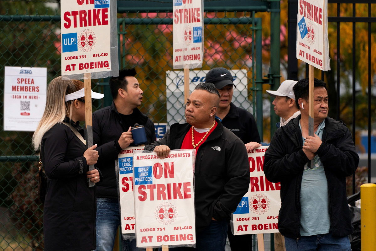 <i>David Ryder/Reuters via CNN Newsource</i><br/>Boeing factory workers and supporters gather on a picket line near the entrance to a Boeing production facility in Renton