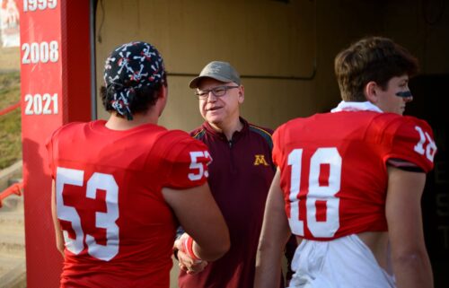 Minnesota Gov. Tim Walz speaks to players on the Mankato West football team on October 11