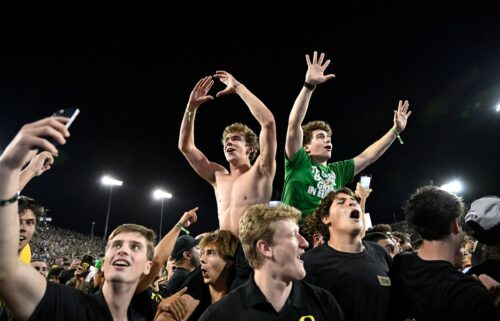 Oregon Ducks fans swarm the field after the game.