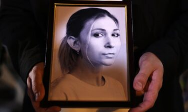 A colleague of Ukrainian journalist Victoria Roshchyna holds a photograph of her during a memorial event in Kyiv.