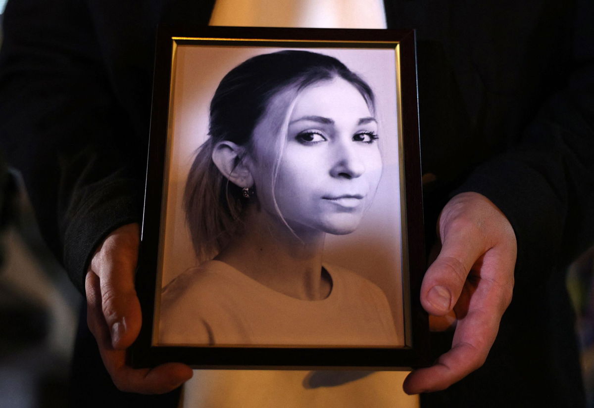 <i>Anatoloo Stepanov/AFP/Getty Images via CNN Newsource</i><br/>A colleague of Ukrainian journalist Victoria Roshchyna holds a photograph of her during a memorial event in Kyiv.