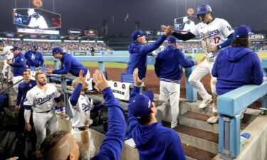 Two-time AL MVP Shohei Ohtani celebrates with teammates after scoring a run during Game 1 of the NLCS against the Mets at Dodger Stadium.