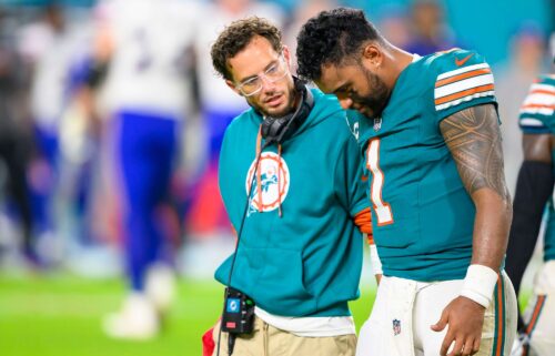 Miami Dolphins quarterback Tua Tagovailoa (right) walks off the field with head coach Mike McDaniel during the game against the Buffalo Bills.