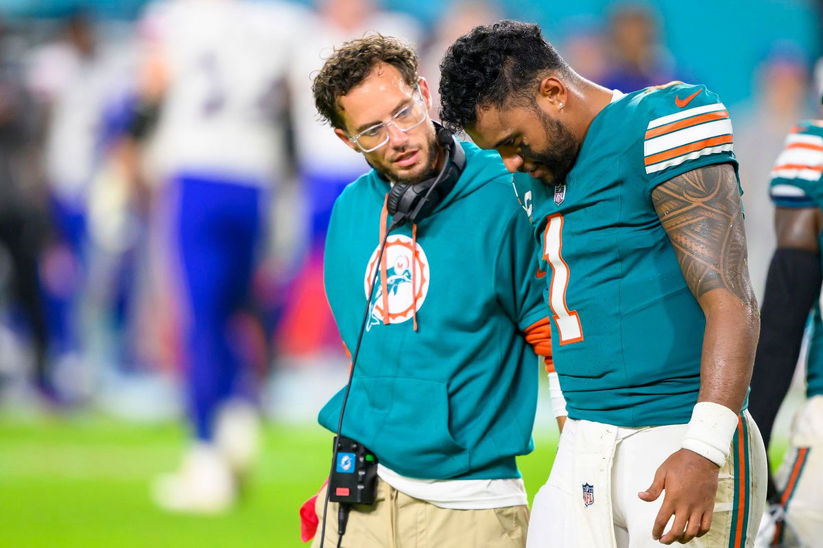 <i>Doug Murray/AP via CNN Newsource</i><br/>Miami Dolphins quarterback Tua Tagovailoa (right) walks off the field with head coach Mike McDaniel during the game against the Buffalo Bills.