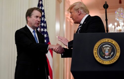 Supreme Court Associate Justice Brett Kavanaugh talks with US President Donald Trump during his ceremonial public swearing-in at the East Room of the White House in Washington