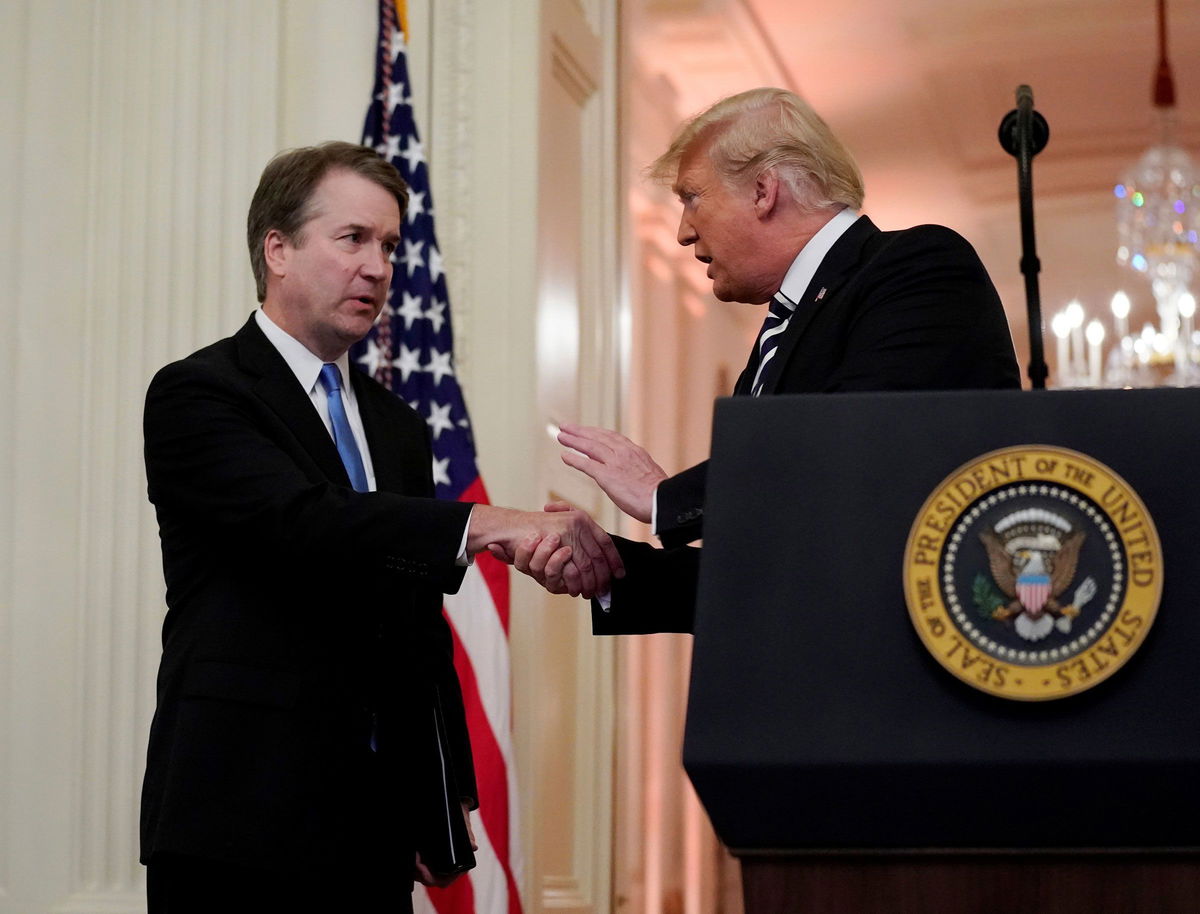 <i>Jonathan Ernst/Reuters via CNN Newsource</i><br/>Supreme Court Associate Justice Brett Kavanaugh talks with US President Donald Trump during his ceremonial public swearing-in at the East Room of the White House in Washington