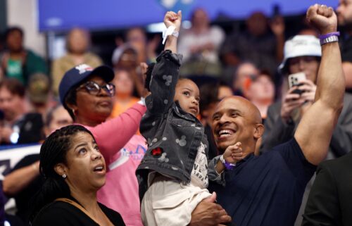 A child gestures during a campaign event for Vice President Kamala Harris at the Dort Financial Center in Flint