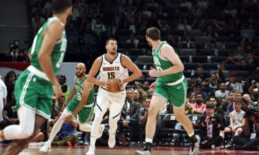 Jokić looks to pass in the NBA preseason game between the Nuggets and the Celtics.