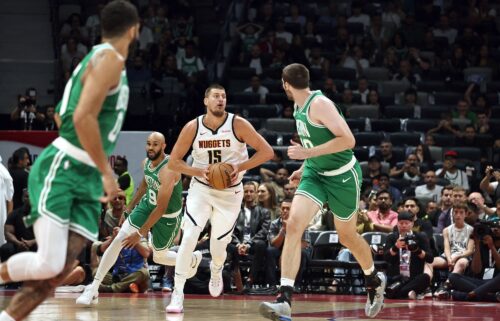 Jokić looks to pass in the NBA preseason game between the Nuggets and the Celtics.