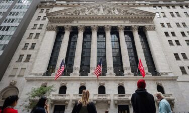 People look toward the New York Stock Exchange (NYSE) before the Federal Reserve announcement in New York City