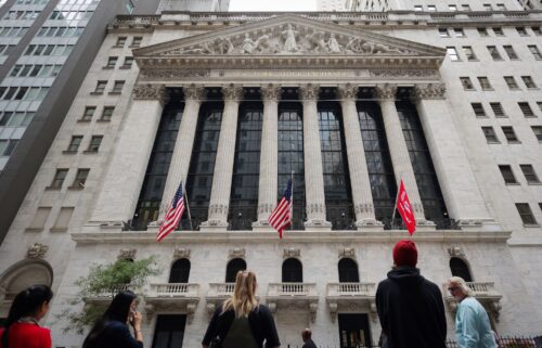 People look toward the New York Stock Exchange (NYSE) before the Federal Reserve announcement in New York City