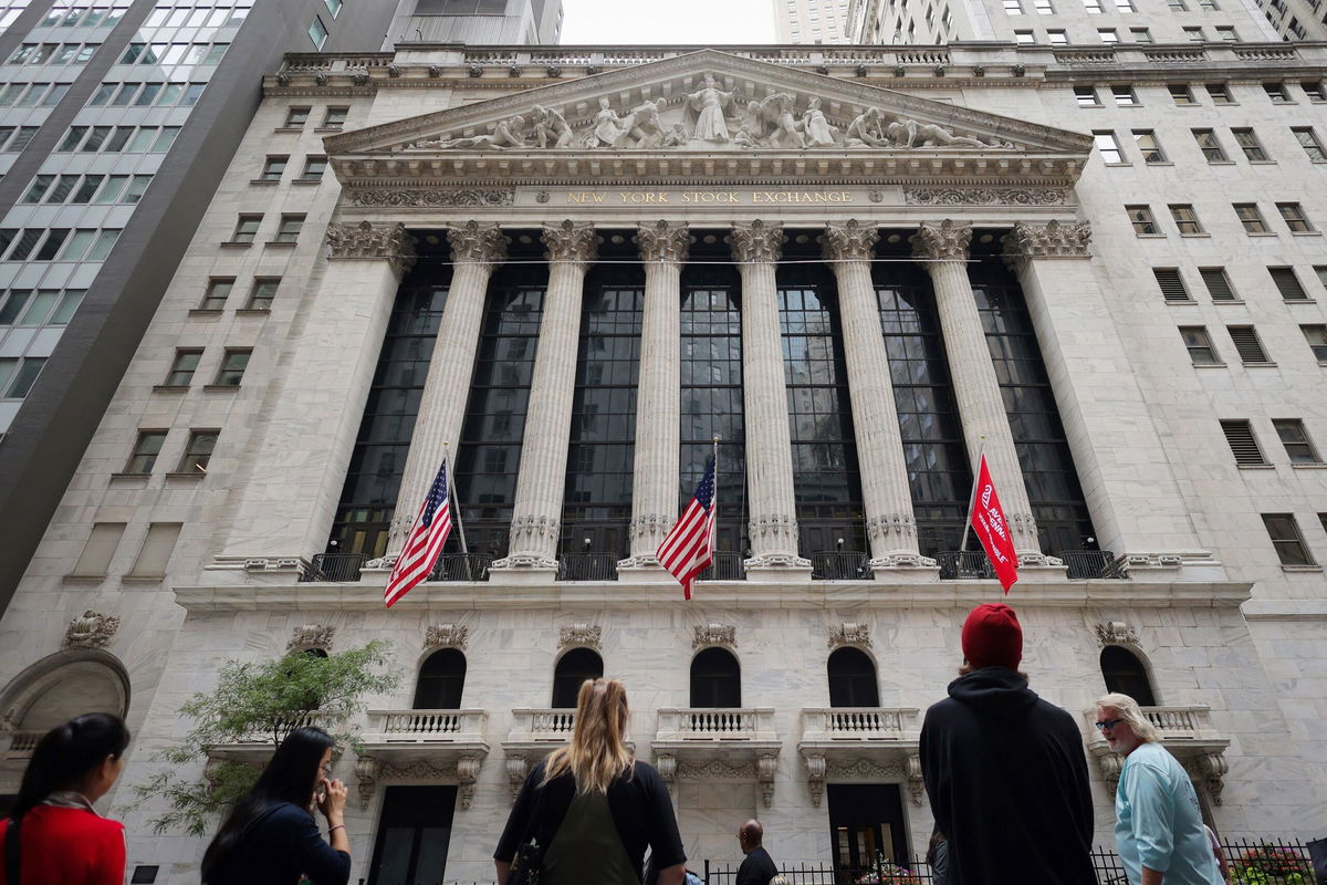 <i>Andrew Kelly/Reuters via CNN Newsource</i><br/>People look toward the New York Stock Exchange (NYSE) before the Federal Reserve announcement in New York City