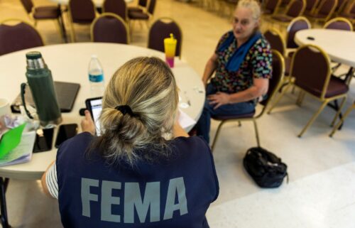 A FEMA worker attends a claim by a local resident after being affected by floods following the passing of Hurricane Helene