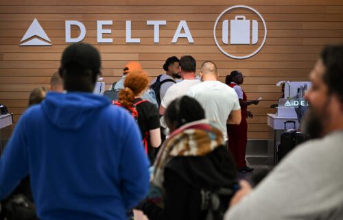 People looking for missing bags wait in line to speak with Delta Air Lines baggage claims employees at the Los Angeles International Airport in July after a service meltdown at the airline caused by the CrowdStrike global software outage.