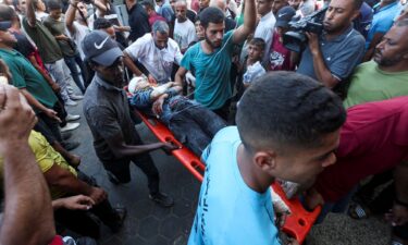 A wounded Palestinian is carried to Al-Aqsa Martyrs Hospital