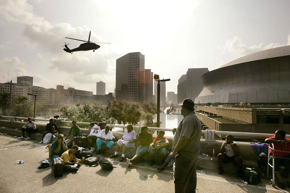 <i>Getty Images via CNN Newsource</i><br/>People seek high ground on Interstate 90 as a helicopter prepares to land at the Superdome in New Orleans in August 2005.