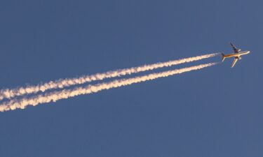 Condensed water trails behind a plane.