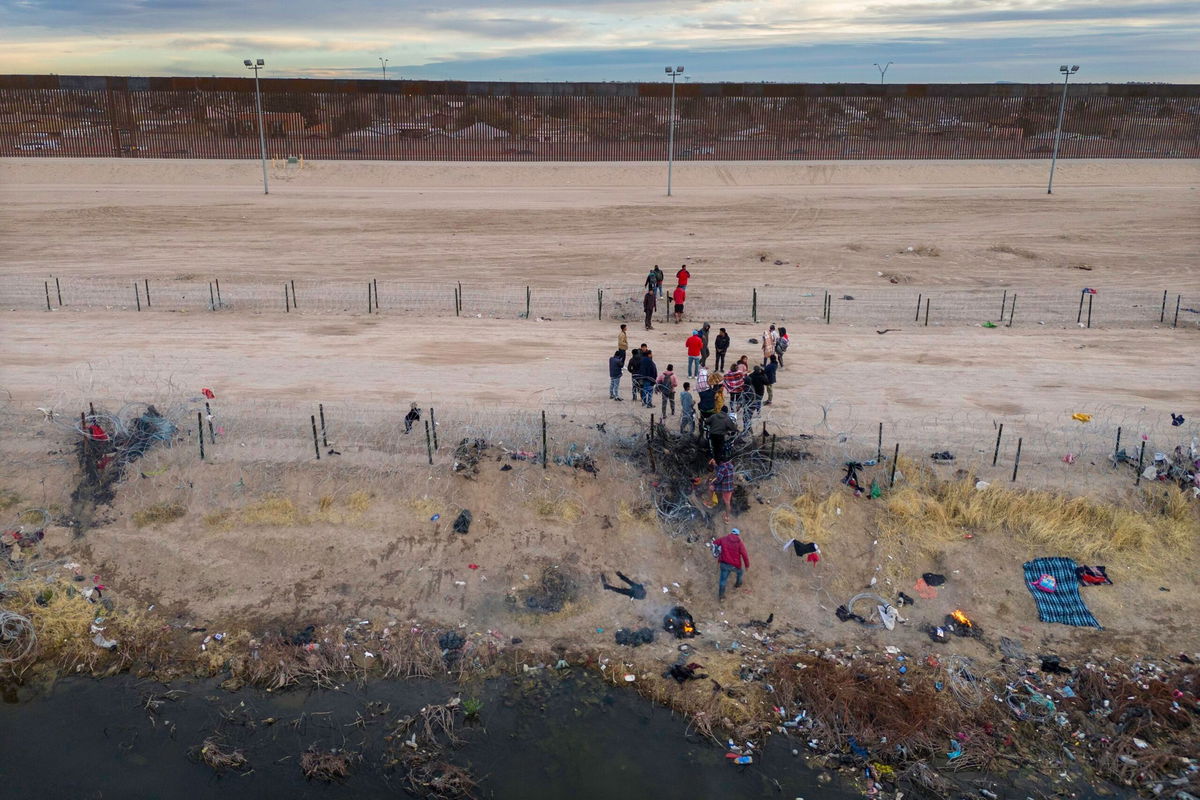 <i>John Moore/Getty Images via CNN Newsource</i><br/>Migrants pass through razor wire after crossing the Rio Grande into El Paso