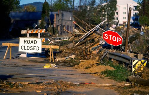 Debris covers a closed street near the Swannanoa River in Asheville