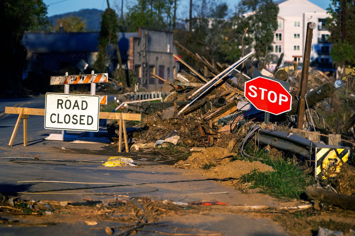 <i>Jim Watson/AFP/Getty Images via CNN Newsource</i><br/>Debris covers a closed street near the Swannanoa River in Asheville