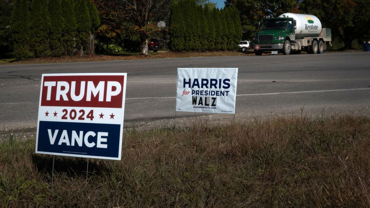 <i>Scott Olson/Getty Images via CNN Newsource</i><br/>Signs showing support for both Kamala Harris and Donald Trump sit along a rural highway near Traverse City