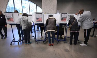 Voters fill in ballots at a voting site set up inside the American Museum of Natural History during the third day of early voting in New York on October 26.