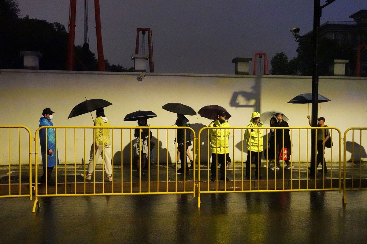 <i>Nicoco Chan/Reuters via CNN Newsource</i><br/>Police officers keep watch near barricades set up along Julu Road where people in Halloween costumes gathered the year before