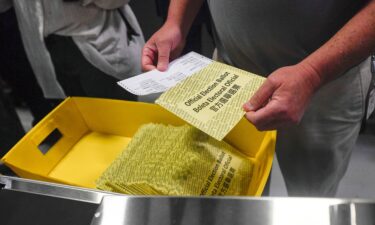 Poll workers demonstrate how ballots are are received