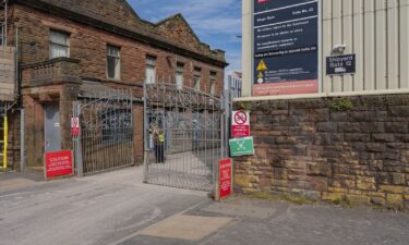 Pictured is an entrance gate to the BAE Systems Plc shipyard in Barrow-In-Furness