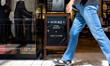 A hiring sign is displayed in front of a store at the Tysons Corner Center mall in Alexandria