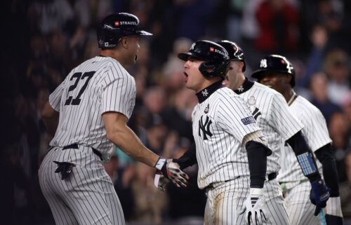 Anthony Volpe is congratulated by his teammates after hitting a grand slam in Game 4.