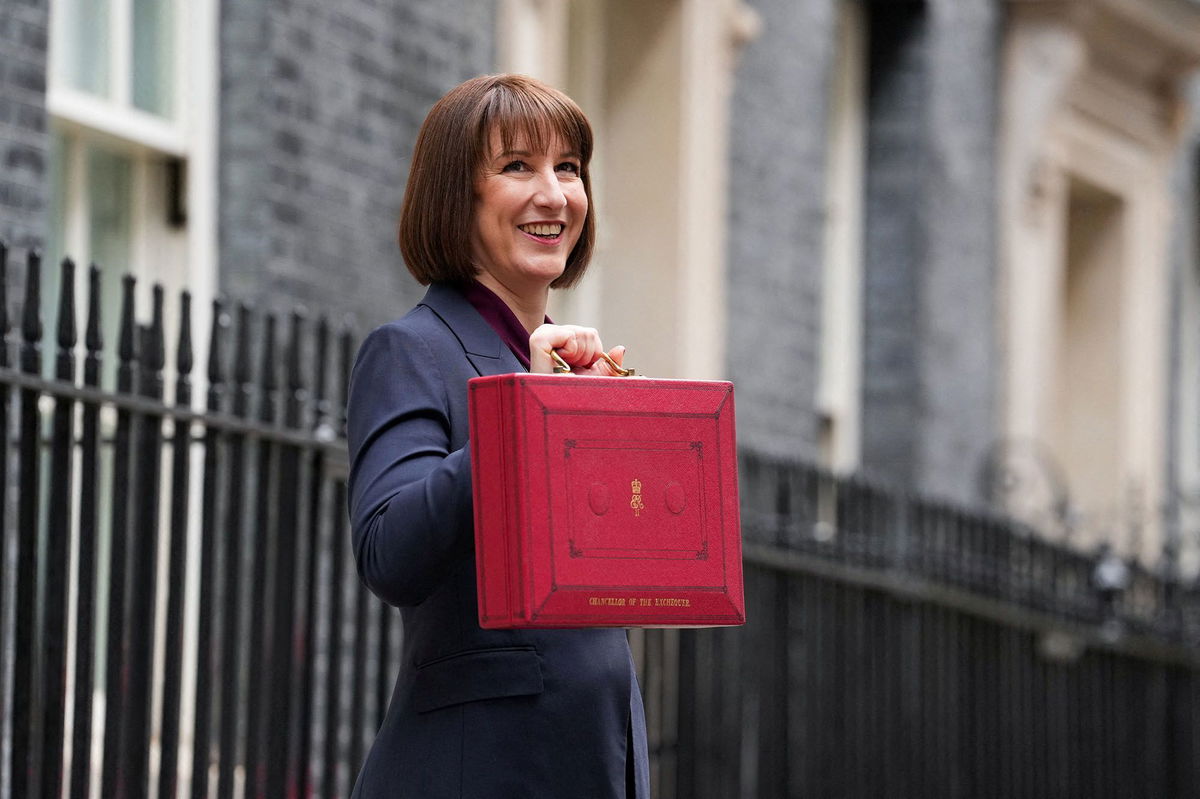 <i>Maja Smiejkowska/Reuters via CNN Newsource</i><br/>Britain's finance minister Rachel Reeves poses with the red budget box outside her office in Downing Street in London on Wednesday