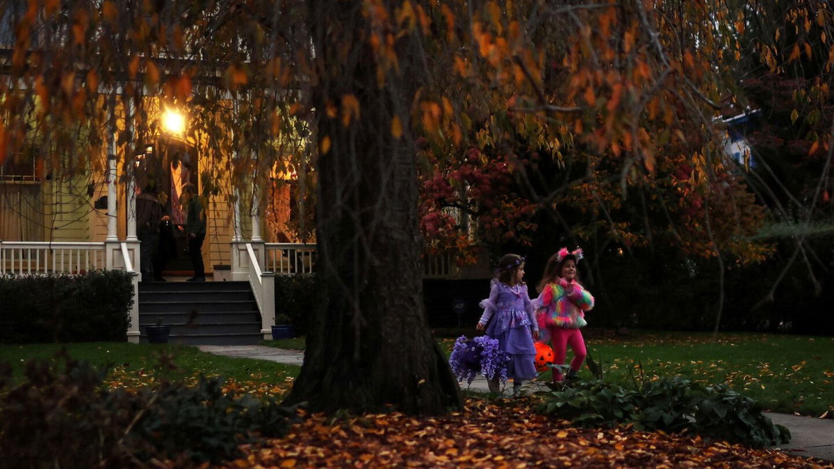 <i>Mike Segar/Reuters/File via CNN Newsource</i><br/>Children go trick-or-treating in the New York suburb of Upper Nyack