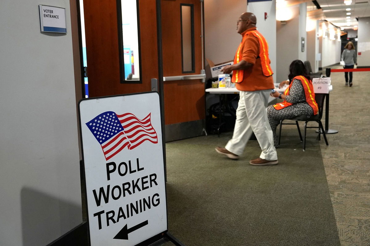 <i>Jayla Whitfield-Anderson/Reuters via CNN Newsource</i><br/>Election workers oversee early election voting at a polling station in Marietta