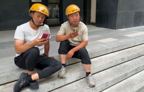 Food delivery worker Yang (left) speaks to CNN about his plight.