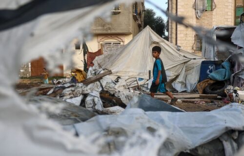 A child walks next to destroyed tents following an Israeli air strike the previous night on the Bureij refugee camp in the central Gaza Strip on October 8.