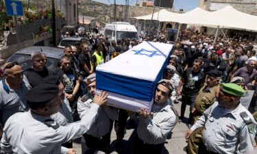 Soldiers carry the coffin of an Israeli Captain who was killed in fighting in southern Gaza