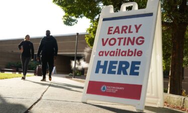 Signs direct people where to go to cast their votes on the first day of early voting at Atlanta Metropolitan State College on October 15 in Atlanta