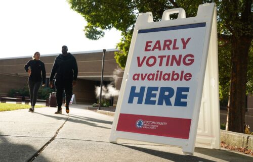 Signs direct people where to go to cast their votes on the first day of early voting at Atlanta Metropolitan State College on October 15 in Atlanta