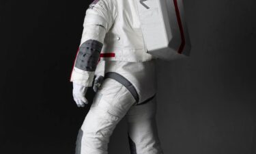 The spacesuit is made from a white material that reflects heat and protects astronauts from extreme high temperatures and lunar dust.