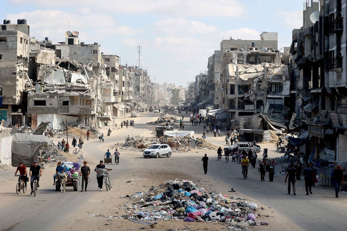 <i>Omar Al-Qattaa/AFP/Getty Images via CNN Newsource</i><br/>Palestinians carry their belongings as they flee areas north of Gaza City in the northern Gaza Strip on October 12. In recent days