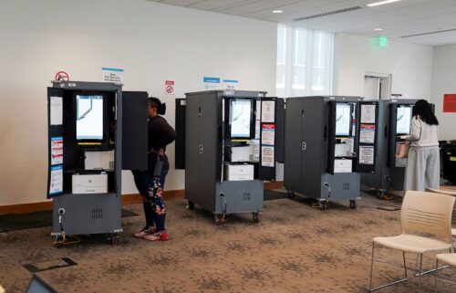 Voters visit a polling station as Georgians turned out a day after the battleground state opened early voting in Atlanta