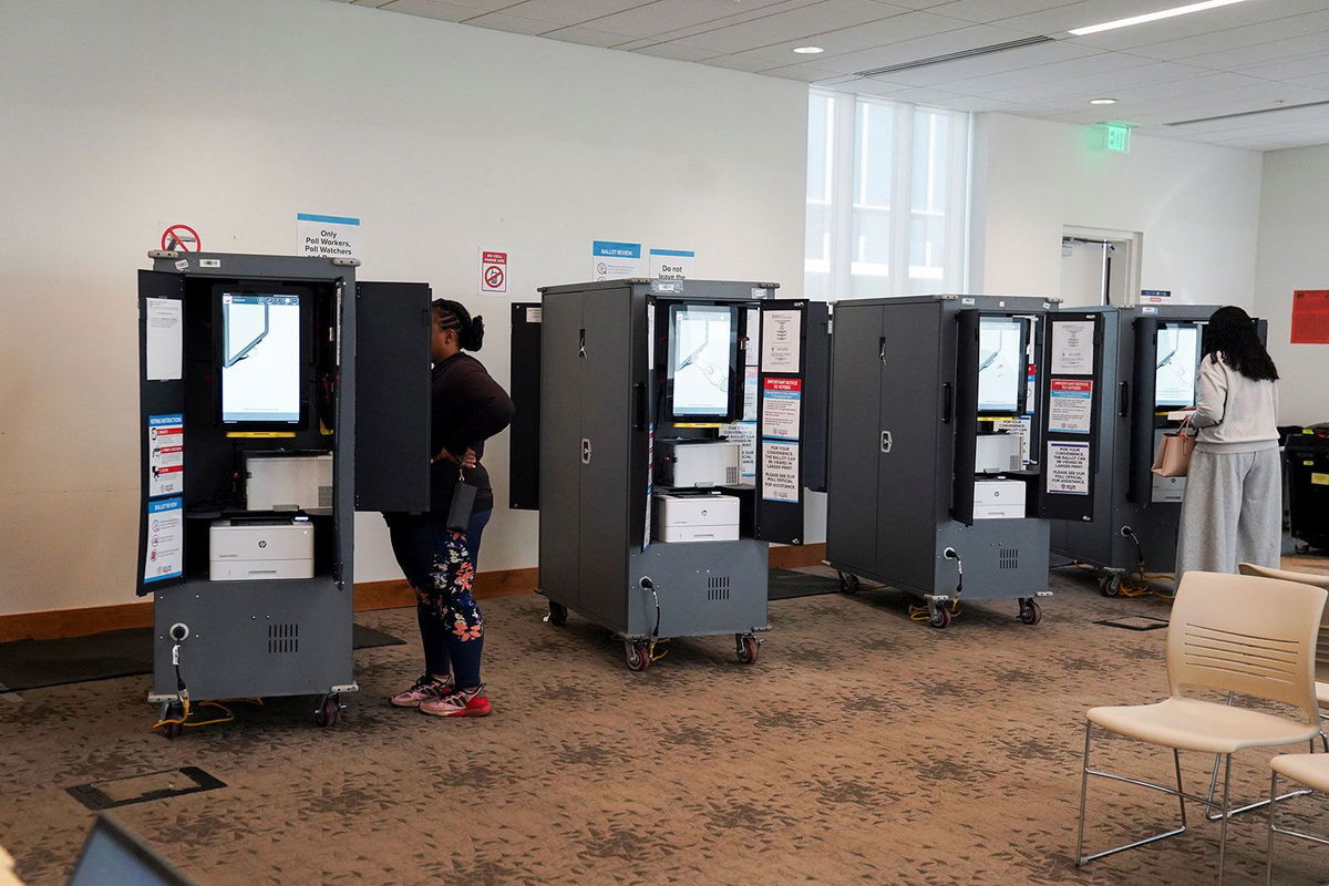 <i>Megan Varner/Reuters via CNN Newsource</i><br/>Voters visit a polling station as Georgians turned out a day after the battleground state opened early voting in Atlanta