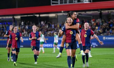 Fridolina Rolfö celebrates with teammate Kika Nazareth after scoring Barcelona's ninth goal from a penalty kick.