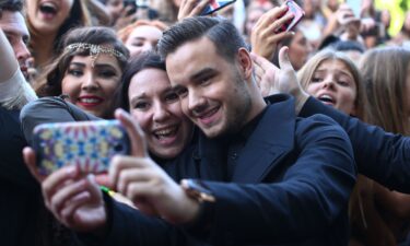 Liam Payne from One Direction takes a selfie with fans in 2014 in Sydney