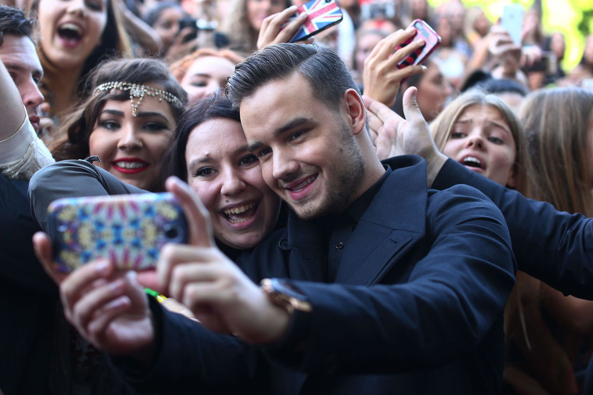 <i>Cameron Spencer/Getty Images via CNN Newsource</i><br/>Liam Payne from One Direction takes a selfie with fans in 2014 in Sydney