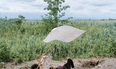 May 2020: A farmer rests while water is pumping from the lagoon to his farm. Extracting water directly from the lagoon has no regulation.