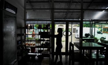 A woman works in a restaurant during a blackout in Havana