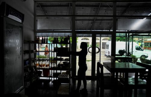 A woman works in a restaurant during a blackout in Havana